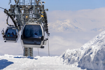 Cable car elevator move from top mountain down ski resort, cloud winter snow day © dramapalma