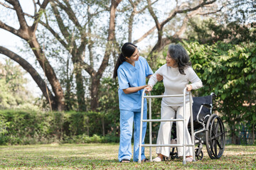 Elderly Woman with Caregiver Assisting in Rehabilitation Outdoors Using a Walker