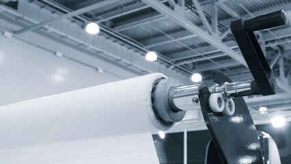 Automatic polyethylene plastic bag production machine with lighting effect. Close-up of the roller...
