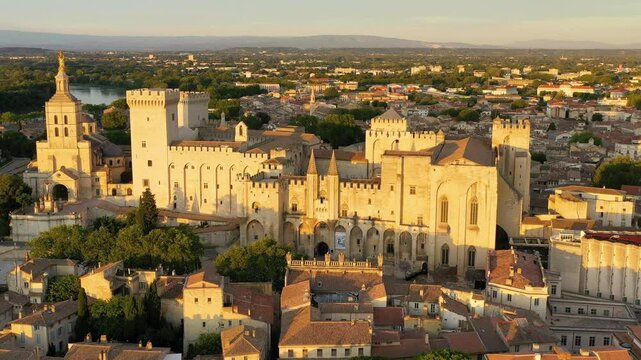 View of Avignon with Palais des Papes during sunset in Southern France. Medieval architecture along the Rhone River in Avignon, Provence, France. The Palais des Papes in Avignon, South France.