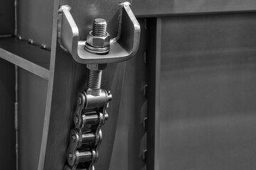 bolt adjusts the tension of the metal chain.