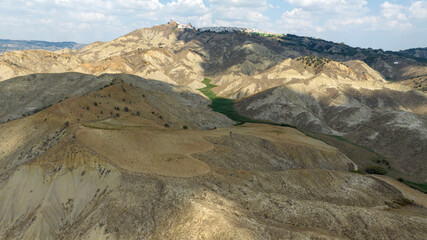 Aerial view of the hills of Basilicata, Italy. In the background you can see the small town of Pisticci, in the province of Matera.