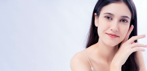 Fototapeta premium A serene portrait of a young woman with a gentle smile and elegant pose, set against a clean white background