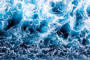 Ocean water texture. Top view of vibrant water with foam. Can be used in covers, packaging, posters, textures, banners, art and design projects. Breathtaking nature background image.