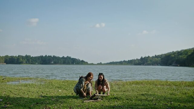 Group of friends escape to holiday  travel together to car camping and remote woking and help each other make a fire.
