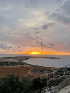 Breathtaking Sunset Over Cavo Greco, Ayia Napa, Cyprus, Highlighting the Rugged Coastal Terrain and Tranquil Mediterranean Waters