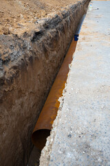 large diameter water pipe in a earthen trench under the asphalt street surface. Repair, renovation or replacement of municipal equipment in the city