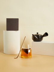 tea bags brewed in a glass, in a beautiful minimalist composition on a beige background