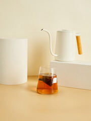 tea bags brewed in a glass, in a beautiful minimalist composition on a beige background