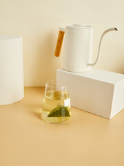 tea bags brewed in a glass, in a beautiful minimalist composition on a beige background