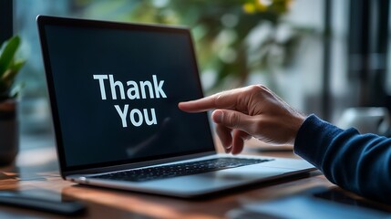 Expressing gratitude thank you message on laptop in office setting