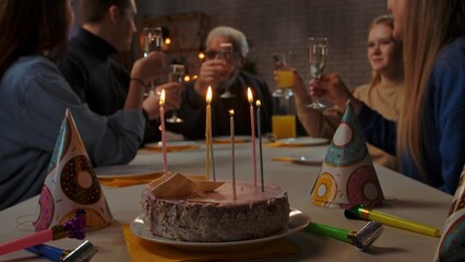 Family sit at table at home, grandchildren and parents celebrating birthday of grandfather, family members and grandpa toasting and cheers.