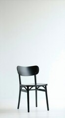 Fototapeta premium Black chair sitting in a white room