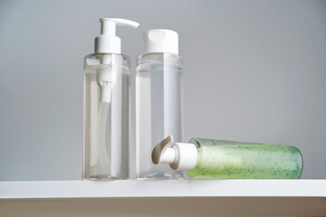 Three bottles of body care products on a white background.