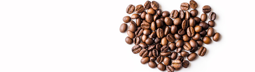 Naklejka premium Heart made of coffee beans isolated on white background. Coffee beans arranged in a heart shape, top view, light background. Heart shape made of coffee beans, Valentine's Day concept, symbol of love