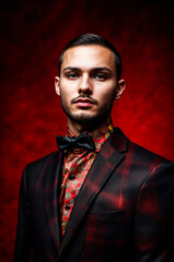 Fototapeta premium Androgynous person in a red background, red light, fashion shot