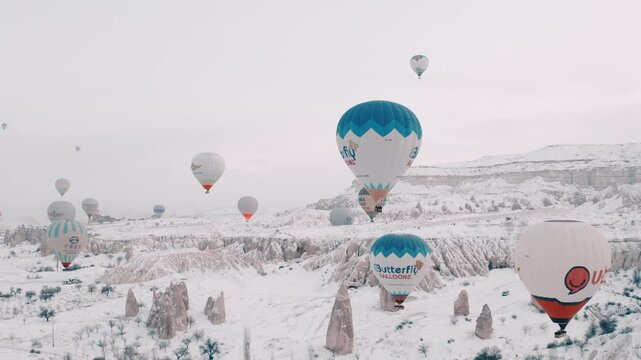 Hot air balloons flying in the snow