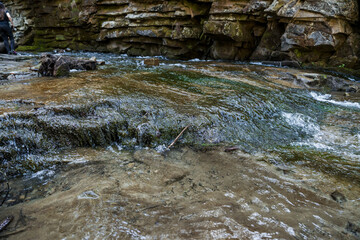 Tranquil Stream Flowing Over Rocky Terrain in a Natural Landscape