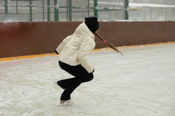 Obraz premium Girl on skates. Winter holidays. Ice skating. Sports details. Exercise on ice.