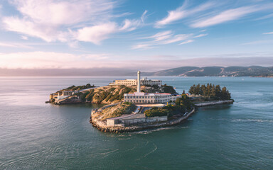 Alcatraz Island aerial view at sunset, showcasing its historic buildings and surrounding bay.