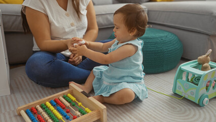 Mother and daughter playing together indoors in a cozy living room, demonstrating love and family bonding with toys and hands-on activities.