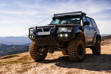 Rugged Off-Road SUV in Mountainous Terrain
