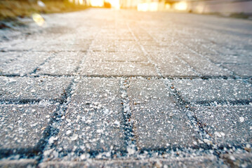 Salt crystals on sidewalk during winter conditions. Excessive winter salt spreading on sidewalks...