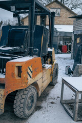 The loader forklift in the snow. Winter snowy day