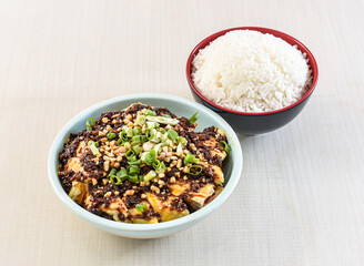 Saliva chicken with white rice topped with nuts served in bowl isolated on white background side view of hong kong food