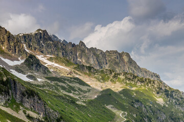 Nasty weather in the Alps. Dark cloudy sky and overcast before the rain and storm. Stormy weather. Snow and rocky summits of the alpine peaks inside the cloud. Aiguilles du Chamonix in autumn 
