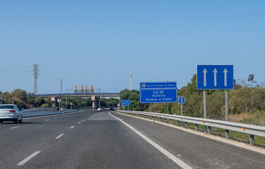 Driving car or family camper in summer, road signs and directions, no traffic jam on touristic road in Andalusia, Spain