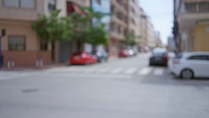 Blurred background with city street scene showing cars and buildings in an out-of-focus urban area on a sunny day