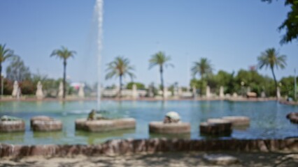 Blurred outdoor scene with defocused fountains and palm trees in a sunny park setting.