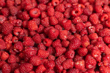 The background image. A large amount of raspberries with a blurred part and a place for text