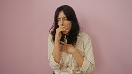 Fototapeta premium Young hispanic woman sick over isolated pink background coughing covering mouth