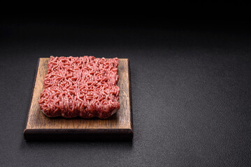 Fresh raw ground minced beef with salt and spices