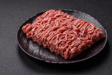 Fresh raw ground minced beef with salt and spices