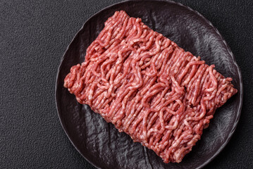 Fresh raw ground minced beef with salt and spices