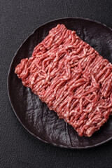 Fresh raw ground minced beef with salt and spices