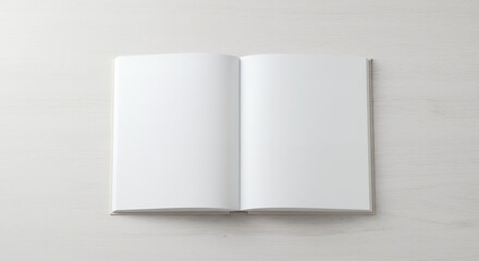 A blank book cover template with an open page on the front side positioned on a white wood background in a flat lay copy space image.