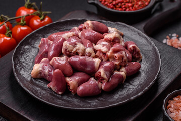 Raw chicken hearts with salt, spices and herbs