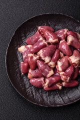 Raw chicken hearts with salt, spices and herbs