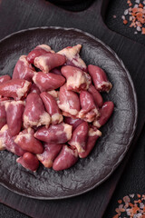 Raw chicken hearts with salt, spices and herbs