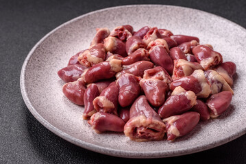 Raw chicken hearts with salt, spices and herbs