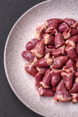 Raw chicken hearts with salt, spices and herbs