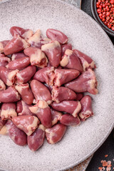 Raw chicken hearts with salt, spices and herbs
