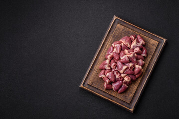 Raw chicken hearts with salt, spices and herbs