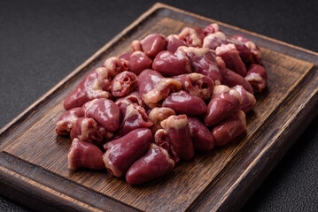 Raw chicken hearts with salt, spices and herbs