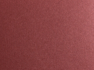 Burgundy red metallic paper texture with a glossy satin finish and subtle gradient. The warm...