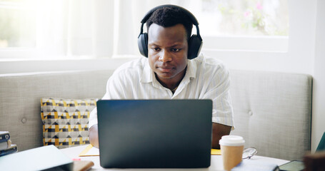 Black man, student and headphones with laptop, home or reading with e learning, scholarship or online course. Person, notes and books with video, education or listening for college project in house